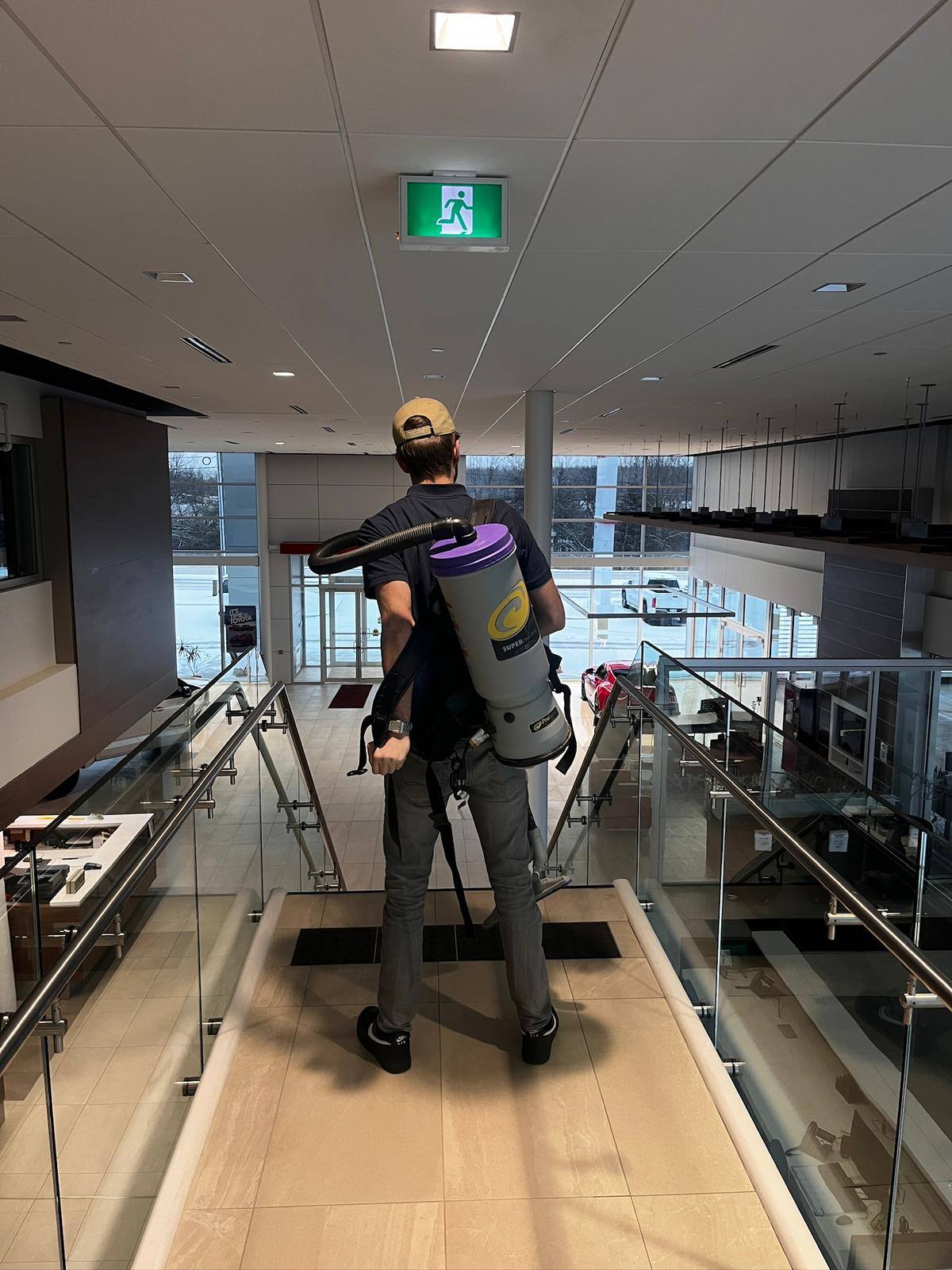 Interior glass railings cleaned using a backpack water system