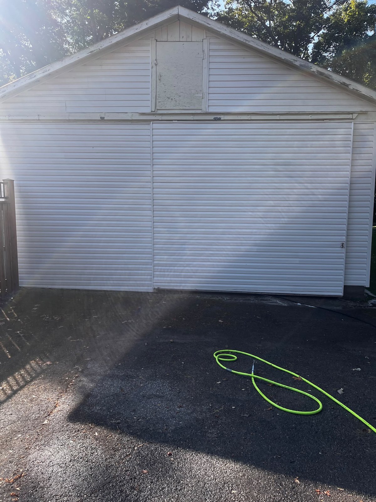 The same garage door and driveway after a wash