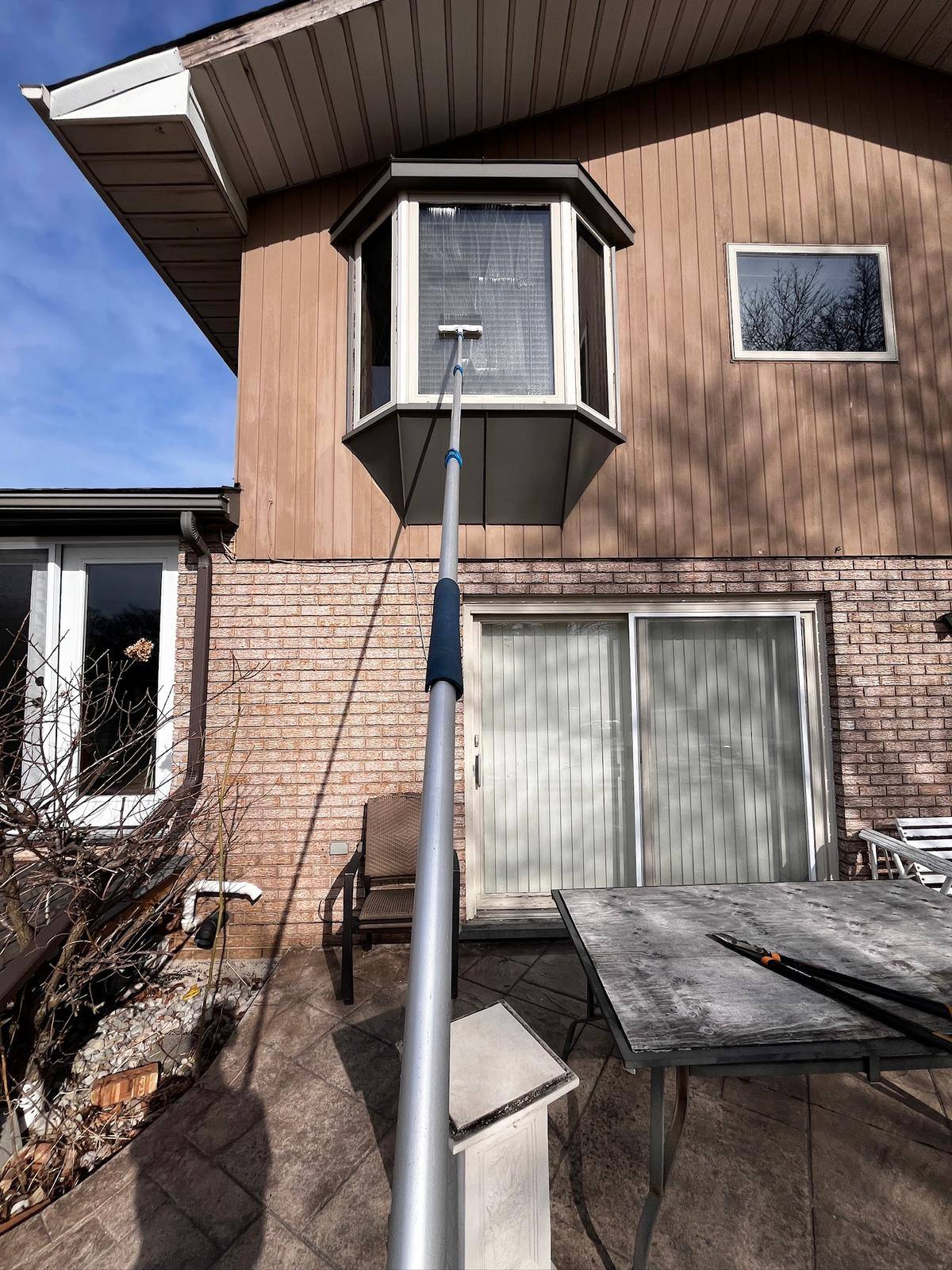 Reaching a bay window with an extension pole