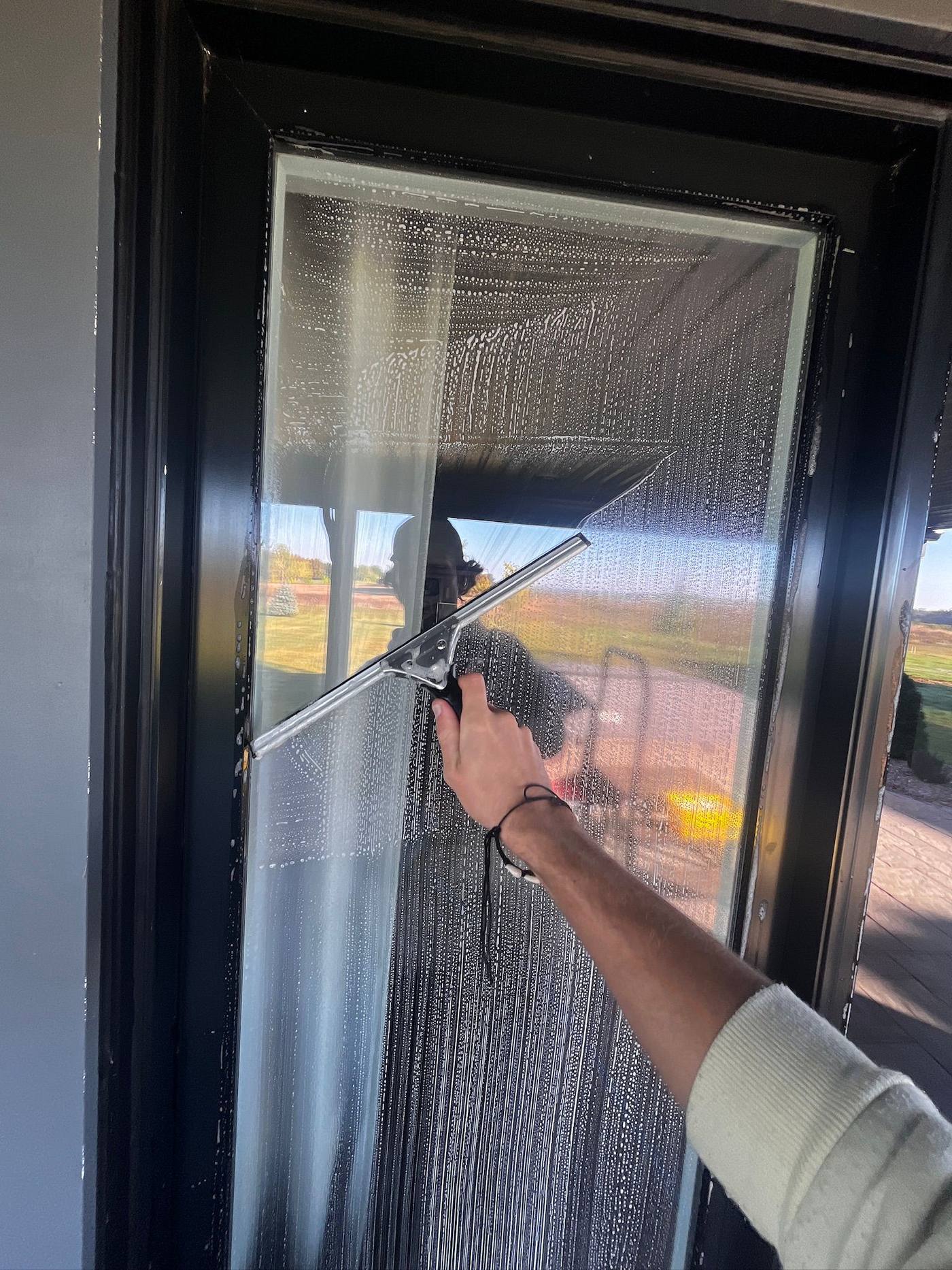 Squeegee drawn down an interior glass door