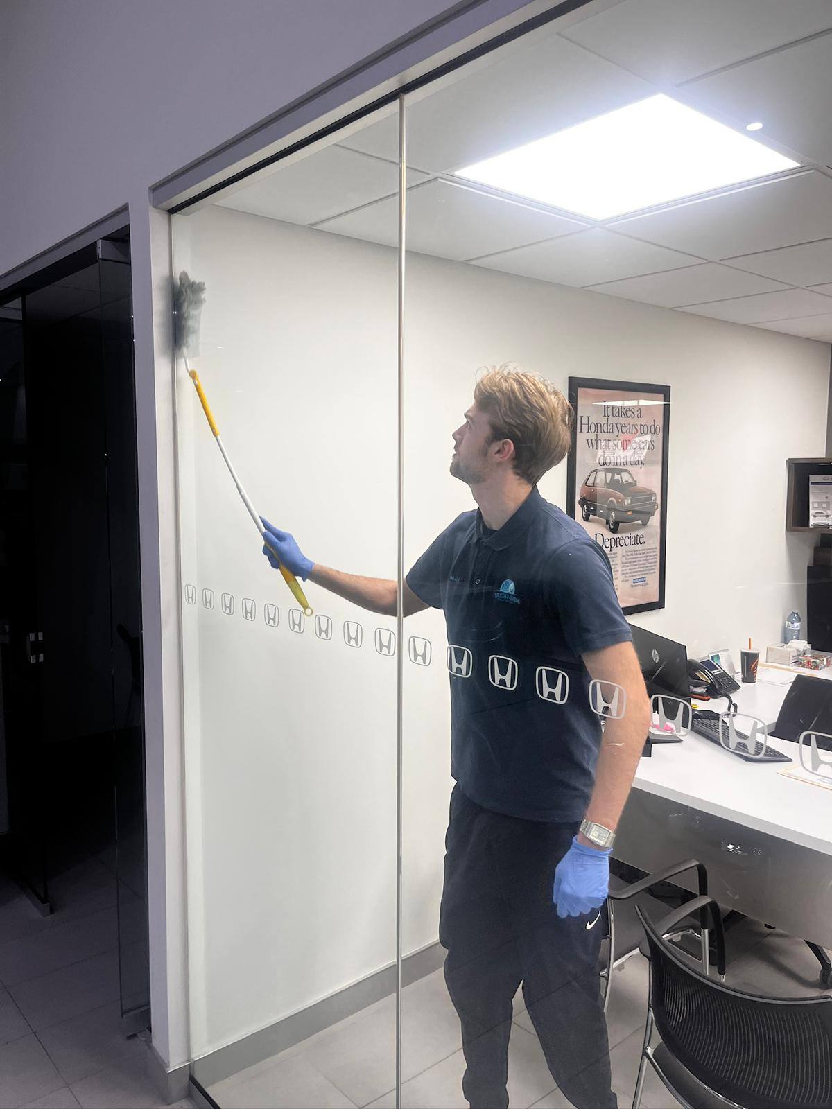 Cleaning an interior glass partition in a dealership office