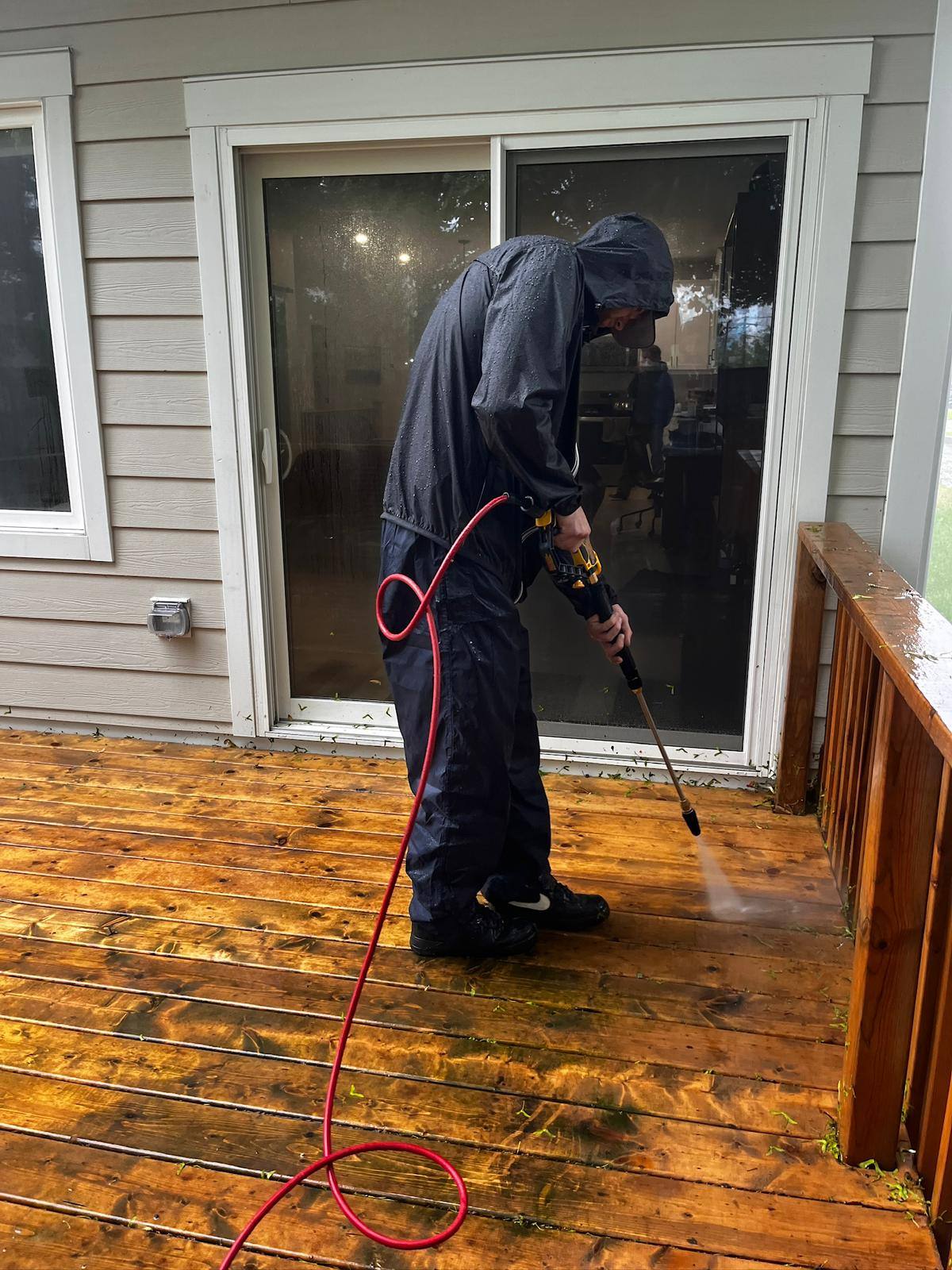 Pressure washing a backyard deck back to bare wood