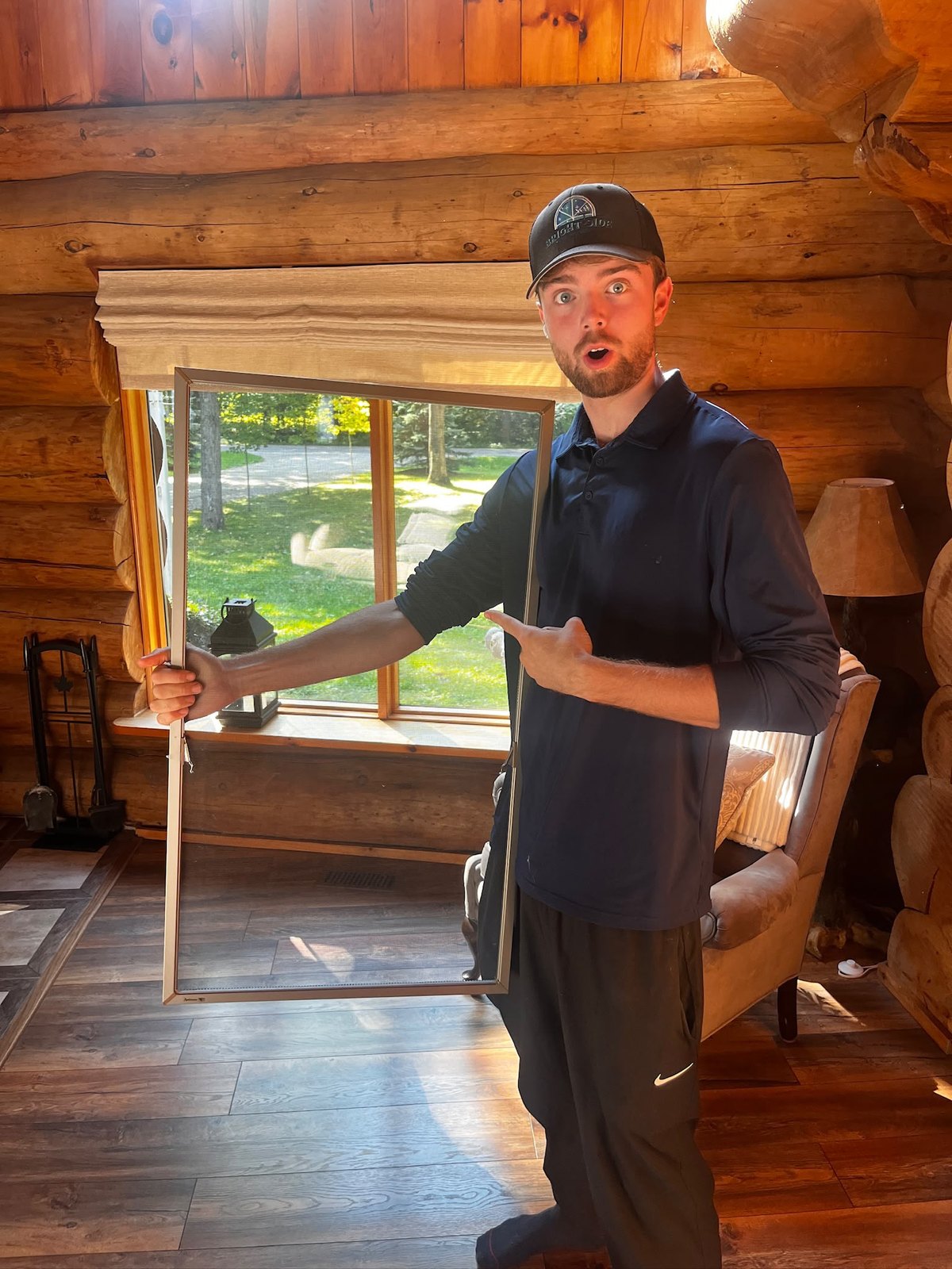 Carrying a window screen out of a log home to be re-meshed