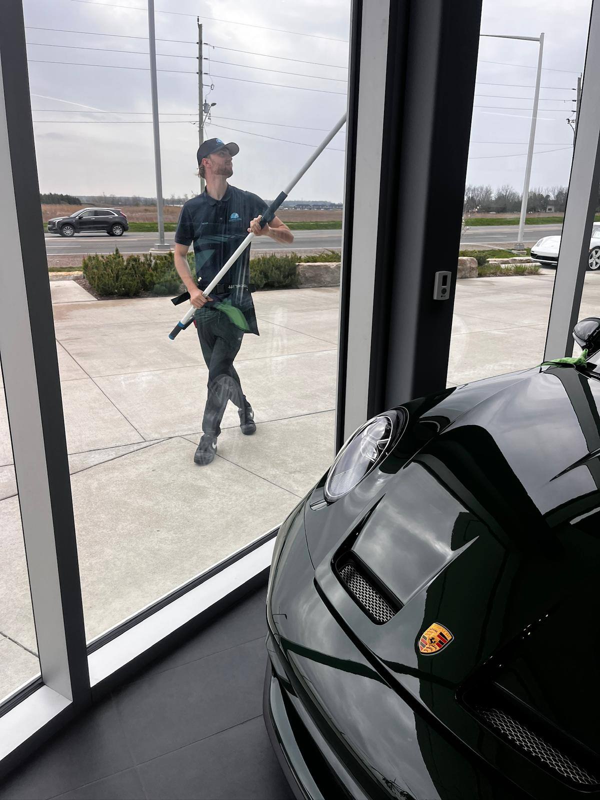 Showroom glass cleaned beside the cars